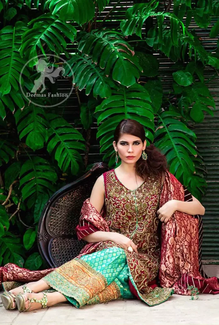 The shirt features beautiful and lovely embellishments all over the shirt. Applique work border implemented on hemline. Deep red and turquoise Crinkle chiffon and Banarsi jamawar. Sharara contains an applique work border at the bottom. Fixed waistband with side zip closure.
