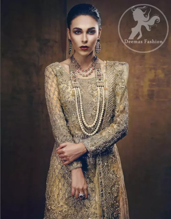 The straight shirt has been adorned with an embellished neckline. The shirt contains embroidered jaal all over. A large embroidered border is implemented at the bottom. Embroidered border implemented at the bottom of the lehenga. Large motifs are scattered all over the lehenga. The bridal dupatta has a four-sided embroidered border with stones sprayed all over it.