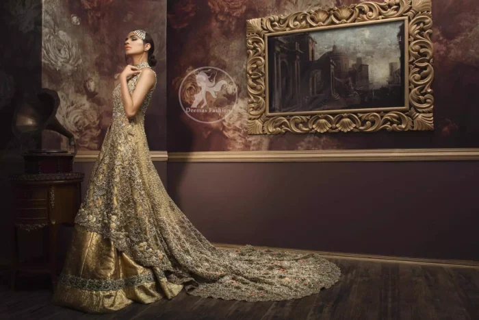 Golden organza lehengha comes with pure crinkle chiffon dupatta having heavy embroidery. Dress comes with front open long back trail gown.  