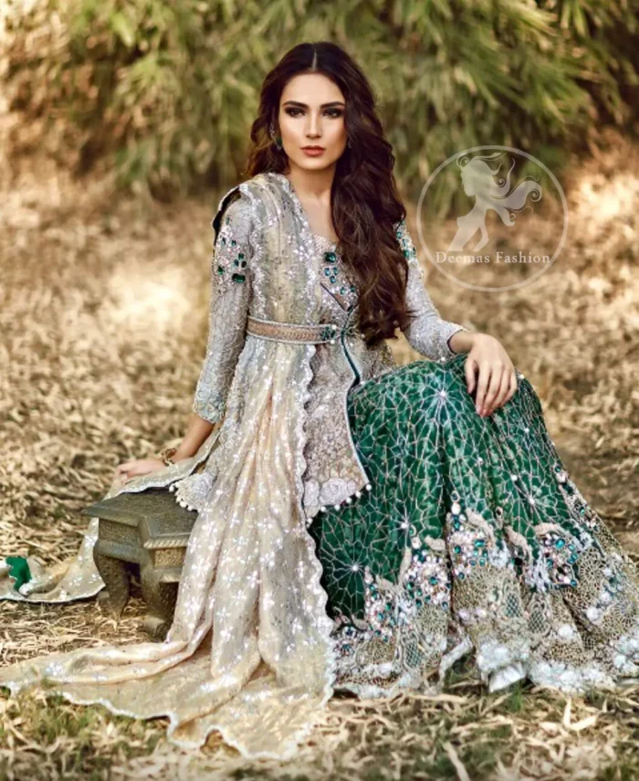 The front open short shirt features marvellous and awesome embellishments accent all over the front and sleeves. Embellished border implemented at the bottom of shirt. Full-length sheer sleeves and Lehenga feature beautiful scalloped work crafted on the bottom with Stunning pearls spray on the bottom.