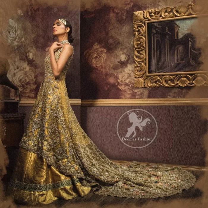 Golden organza lehenga comes with a pure crinkle chiffon dupatta having heavy embroidery. The dress comes with a front-open long-back trail gown.