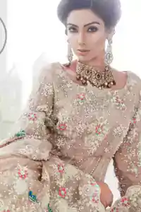 Light Fawn Back Trail Frock - Peach Jamawar Lehenga. The frock features beautiful embellishments that accentuate the neckline, all over the bodice, front flared, and a working border on the hemline