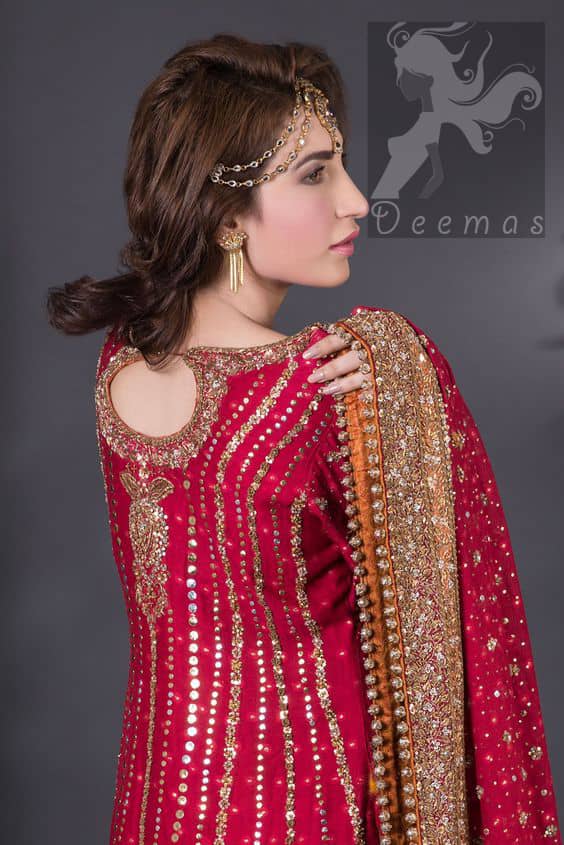 Crimson A-line slits shirt adorned with beautiful neckline, stripes and hemline. Matching dupatta having embellished border on four sides, sequins and small motifs spray all over it. Lehenga in Crimson and Copper having embellished Gott like gharara (below the knee), stripes and small motifs spray. Embellishment in light and dark antique shades.