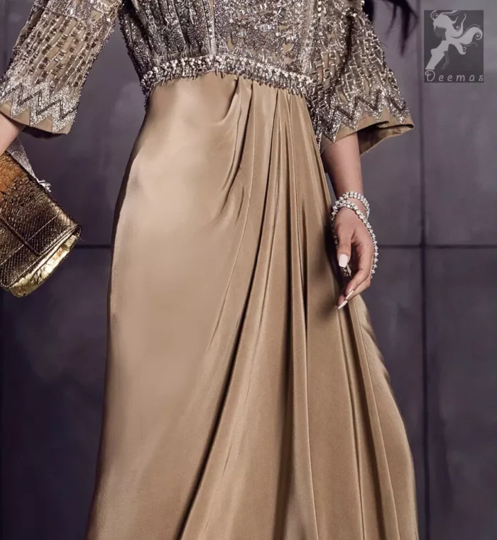 Fawn brown silky maxi has embellished bodice and sleeves. Bodice and sleeves have been embellished with dark gray embellishment and ivory pearls.