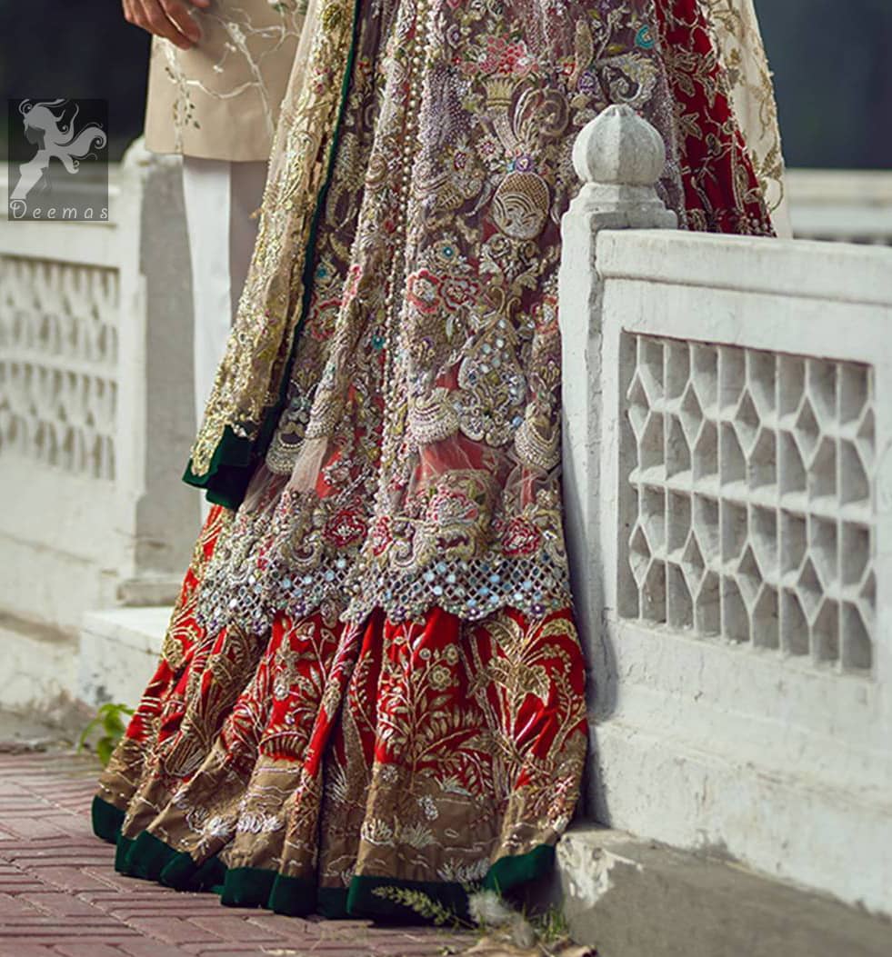 Light fawn pure crinkle chiffon front slits gown adorned with beautiful colorful embellishment. Red lehengha adorned with embellishment all over it. Light pistachio dupatta having embellished border on sides and motif spray all over it and finished with piping.