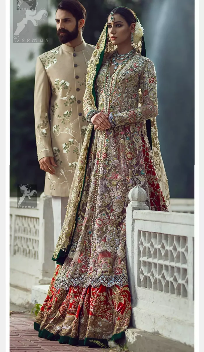 Light fawn pure crinkle chiffon front slits gown adorned with beautiful colorful embellishment. Red lehengha adorned with embellishment all over it. Light pistachio dupatta having embellished border on sides and motif spray all over it and finished with piping.