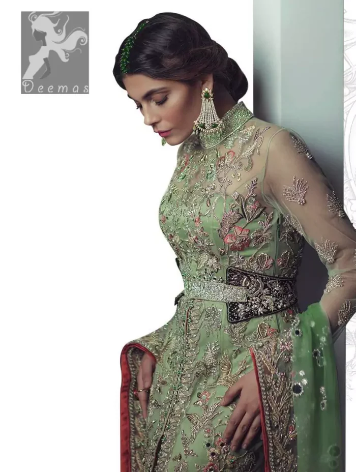 Pistachio green gown having high neck gown. Embellished Bodice with waist belt and front open slits. Mehndi green trousers having embellishment on cuffs and motifs. Pistachio green net dupatta having embellished border and round motifs all over it.