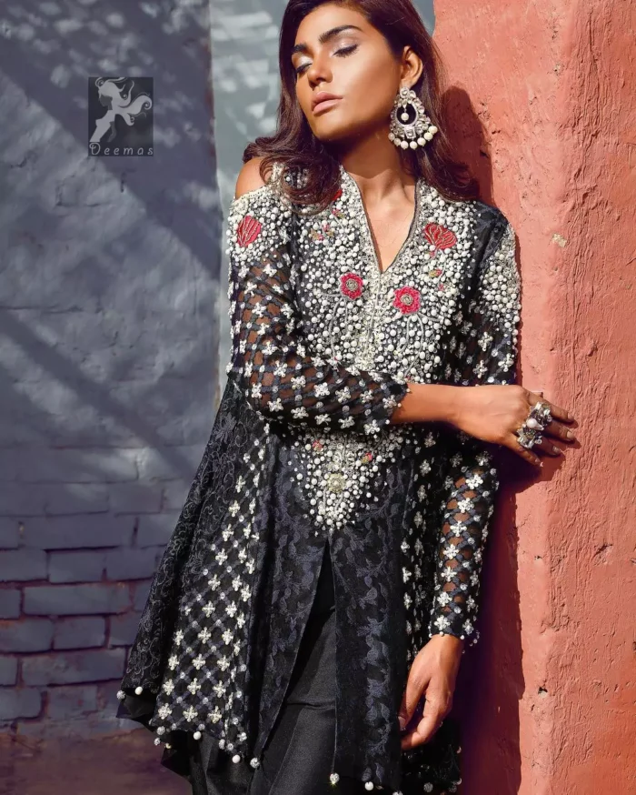 Black peplum made with pure banarsi jamawar chiffon. Peplum having multiple panels of different banarsi patterns. White and silver embellishment on neckline, side panels and sleeves. Pure raw silk sharara pants.