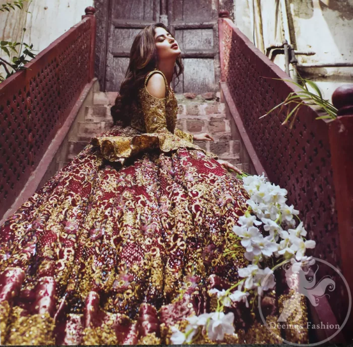 Alpine Blouse is of pure tissue. Top has cold shoulders design also having umbrella shaped sleeves. Blouse has been embellished with antique shades of embellishment. Wineberry heavy embellished lehengha featuring swarovski, crystals, pearls and golden shaded kora, dabka and naqshi. It has been adorned with beautiful different shaded embellishment also having large appliqued border on hemline. It is artistically coordinated with maroon dupatta which  is fully decorated with appliqued border on edges and wavy sequins pattern all over it.