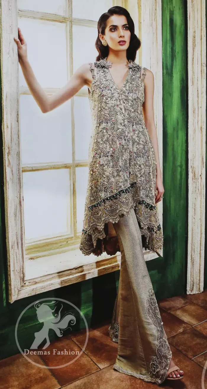 Grey olive floral embroidered high and low front open short frock. Frock is finessed with kora, dabka, pearls, sequins and swarovsky. The daman of the frock is beautifully enhanced with scalloped border and silhouettes. This shirt is adorned with 3D floral embroidered motifs having V shaped neckline. Top is coordinated with pajama having embroidered motifs.
