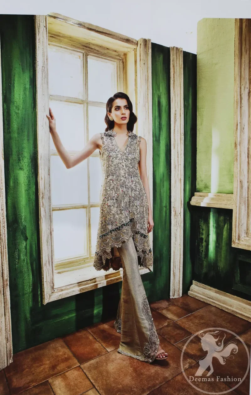 Grey olive floral embroidered high and low front open short frock. Frock is finessed with kora, dabka, pearls, sequins and swarovsky. The daman of the frock is beautifully enhanced with scalloped border and silhouettes. This shirt is adorned with 3D floral embroidered motifs having V shaped neckline. Top is coordinated with pajama having embroidered motifs.