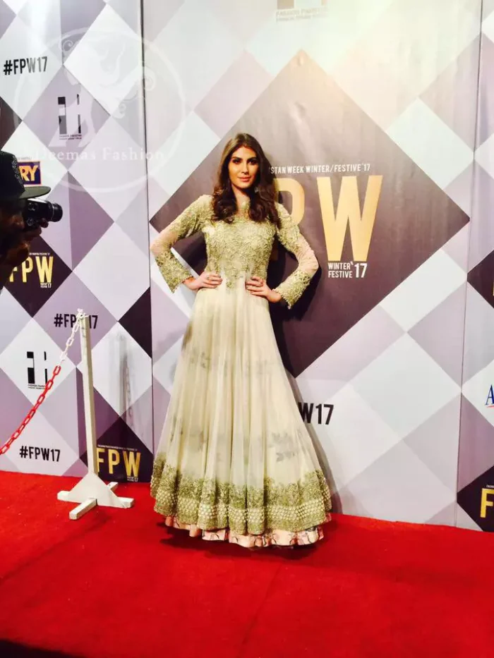 Ivory floor length Anarkali embellished with floral embroidery. Front and back bodice is fully embroidered with dull golden and antique shades of kora, dabka, tilla, pearls and sequins. There is beautiful cutwork and embroidery on sleeves cuffs and near the shoulders. Its hemline is allured with two delicate appliqued borders. One of them is of white pearls and the other one is of delicate embroidery.  This dress is artistically coordinated with simple ivory brocade lehengha and delicate tissue dupatta. Dupatta is adorned with cutwork and embroidery on pallu and there is small floral embellishment pattern on dupatta.
