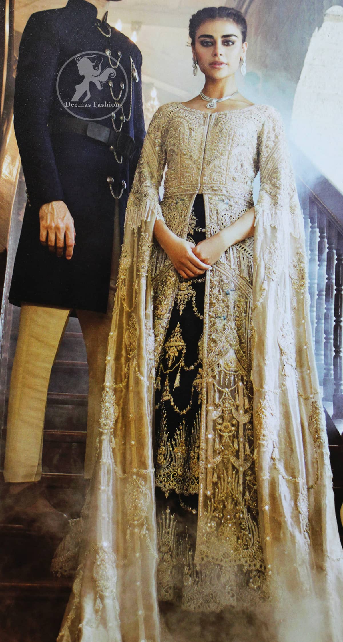 An ivory front open tissue shirt with heavy embroidery decorated with dull golden and champagne kora, dabka, tilla, naqshi, sequins and swarovski. It is further allured with cutwork and floral embroidery. Its umbrella sleeves is embellished with delicate zari work. Its black inner shirt is also embroidered. This outfit is artistically coordinated with black chiffon sharara which is allured with floral embroidery. This outfit is fully scalloped and enhanced by a thick floral embellished pattern. Dress comes with ivory dupatta which has finished edges and having sprinkled sequins pattern all over it.