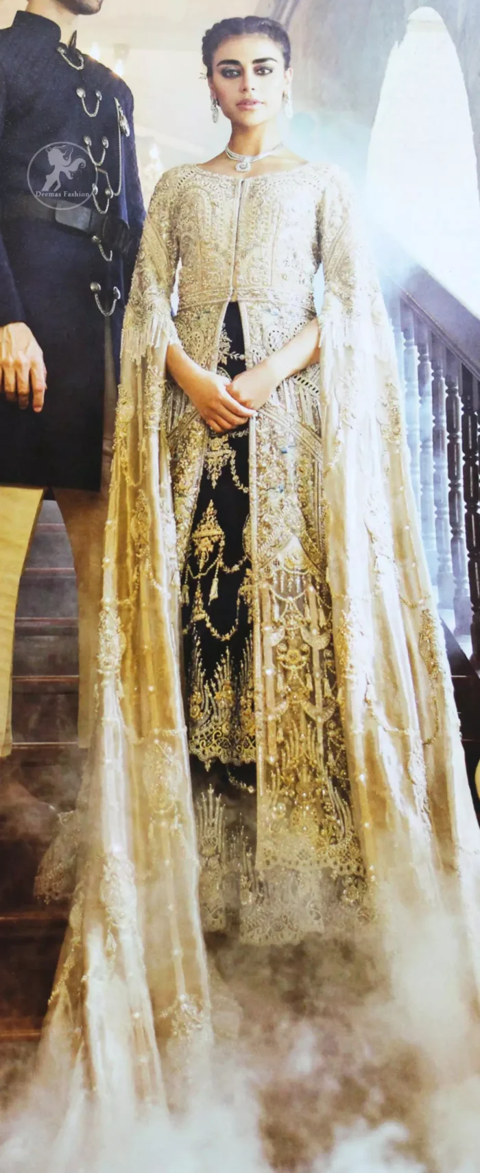 An ivory front open tissue shirt with heavy embroidery decorated with dull golden and champagne kora, dabka, tilla, naqshi, sequins and swarovski. It is further allured with cutwork and floral embroidery. Its umbrella sleeves is embellished with delicate zari work. Its black inner shirt is also embroidered. This outfit is artistically coordinated with black chiffon sharara which is allured with floral embroidery. This outfit is fully scalloped and enhanced by a thick floral embellished pattern. Dress comes with ivory dupatta which has finished edges and having sprinkled sequins pattern all over it.