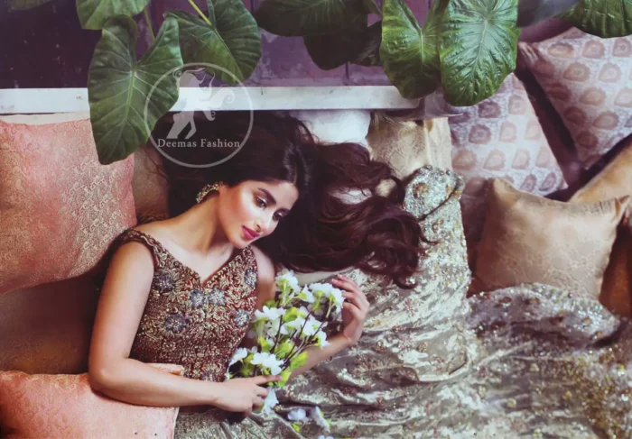 Redish brown exuberant velvety blouse is highlighted with moti, kora, dabka, pearls, swarovski, crystals, and sequins. This sleeveless blouse is allured with gorgeous shades of zari embroidery . It has V shaped neckline. Lehengha is of grey colour, adorned with beautiful different shaded embellishment.  Lehengha is decorated with floral pattern. It is artistically coordinated with brown dupatta which  is decorated with floral and sequins pattern all over it
