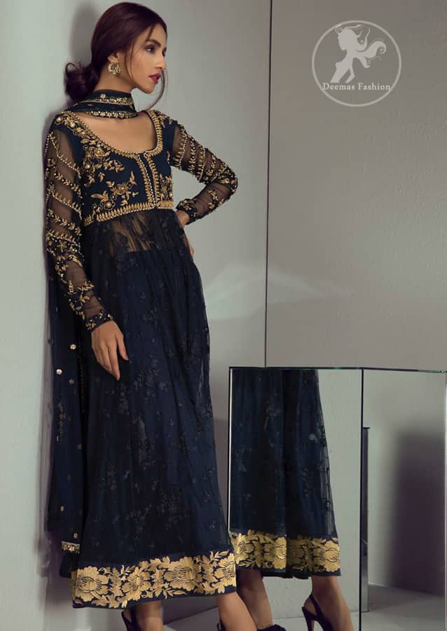 Look alluring in this floor length frock embellished with golden kora dabka, intricate embroidered motifs and detailed bodice. The border on the daman is enhanced with thread embellished floral pattern detailing that instantly draws attention. It comes with matching cigarette pants. It is paired up with dark blue dupatta with sequins sprinkled and finished with light embroidered edges.