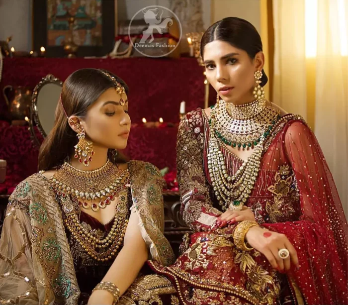 This maroon angrakha frock heavily embellished in the front with silver gold kora dabka, kundan and stones work. One side shoulder neckline is beautifully ornamented with sequins lines in geometric manner. Paired up with matching brocade sharara which looks so magnificent. This outfit is meticulously coordinated with maroon dupatta with embellished borders on lengths.