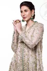 This sides-down short frock is decorated with kora, dabka, tilla, sequins and pearls. It is embellished with floral embroidery. It is further enhanced with an embroidered scalloped border which adds to the look. It comes with sharara which is adorned with floral motifs all over it. It is beautifully coordinated with a chiffon dupatta which is sprinkled with sequins all over.