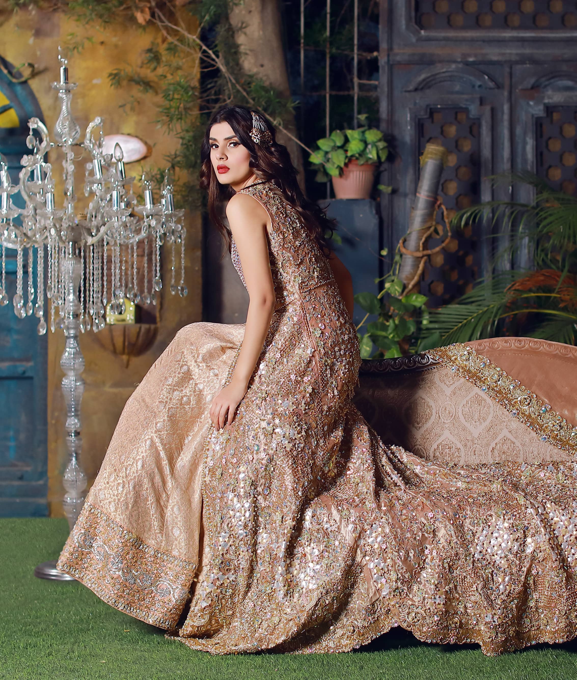 This dress is beautifully sculptured with floral embroidery. It is meticulously highlighted with silver kora, dabka, tilla, sequins and pearls. Back is fully embroidered. Trail is magnificently decorated with scalloped border. Beautiful bodice adds to the look. Inner of this trail is of brocade which has thick embellished border. Complete the look with embellished dupatta.