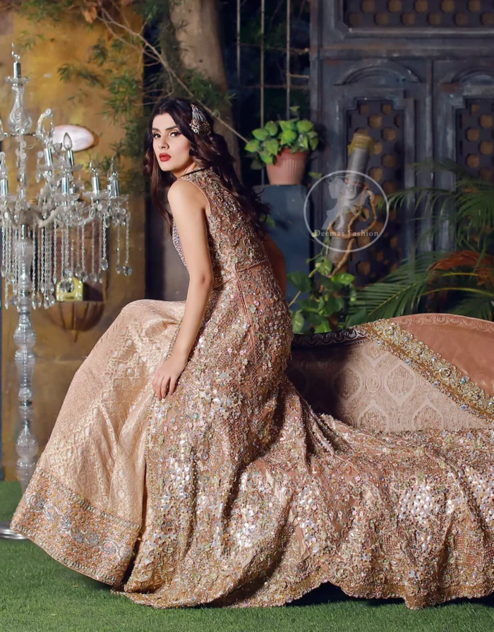 This dress is beautifully sculptured with floral embroidery. It is meticulously highlighted with silver kora, dabka, tilla, sequins and pearls. Back is fully embroidered. Trail is magnificently decorated with scalloped border. Beautiful bodice adds to the look. Inner of this trail is of brocade which has thick embellished border. Complete the look with embellished dupatta.