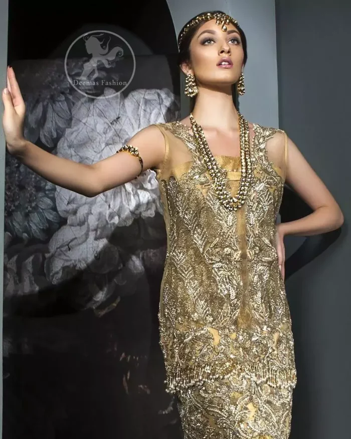 This dress is beautifully sculptured with floral embroidery. It is meticulously highlighted with antique shaded kora, dabka, tilla, sequins and pearls. It is allured with beautiful tassels which adds to the look. It is beautifully paired up with embroidered brocade sharara. It comes with organza/tissue dupatta which has four sided embellished border and applique.