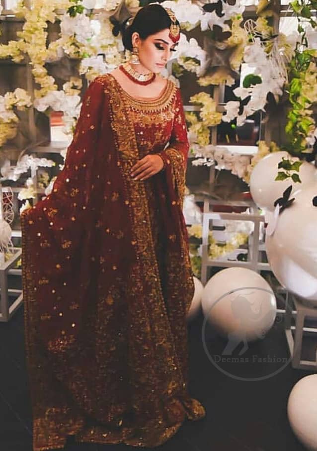 This dress is beautifully sculptured with floral embroidery. It is allured with red, dull golden, champagne and antique shaded kora dabka, tilla, sequins and pearls. It is adorned with beautiful U-shaped embellished neckline which adds to the look.It is artistically coordinated with rust embellished lehenga. It comes with burnt red dupatta which has heavy work on pallu and four sided embroidered border. Dupatta is sprinkled with small sized floral motifs all over.