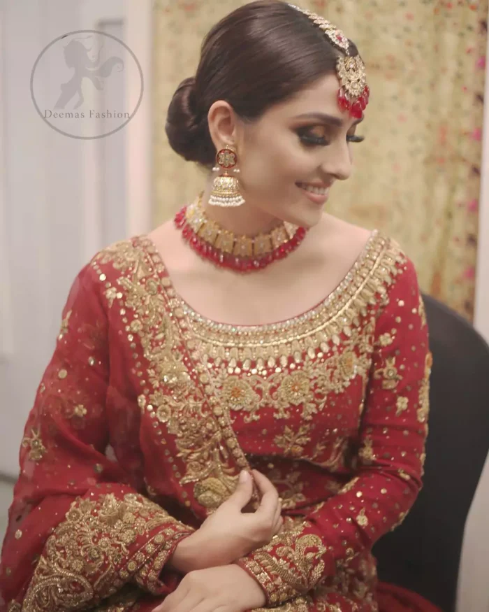 This dress is beautifully sculptured with floral embroidery. It is allured with red, dull golden, champagne and antique shaded kora dabka, tilla, sequins and pearls. It is adorned with beautiful U-shaped embellished neckline which adds to the look.It is artistically coordinated with rust embellished lehenga. It comes with burnt red dupatta which has heavy work on pallu and four sided embroidered border. Dupatta is sprinkled with small sized floral motifs all over.