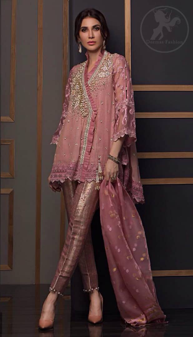 This outstanding angrakha style shirt meticulously highlighted with dull golden and antique shaded kora, dabka , tilla, sequins and pearls. This dress is beautifully adorned with floral embroidery. Sleeves are decorated with resham embroidery which adds to the look. It comes with brocade pajama. It is beautifully coordinated with chiffon dupatta having sprinkled sequins all over it.