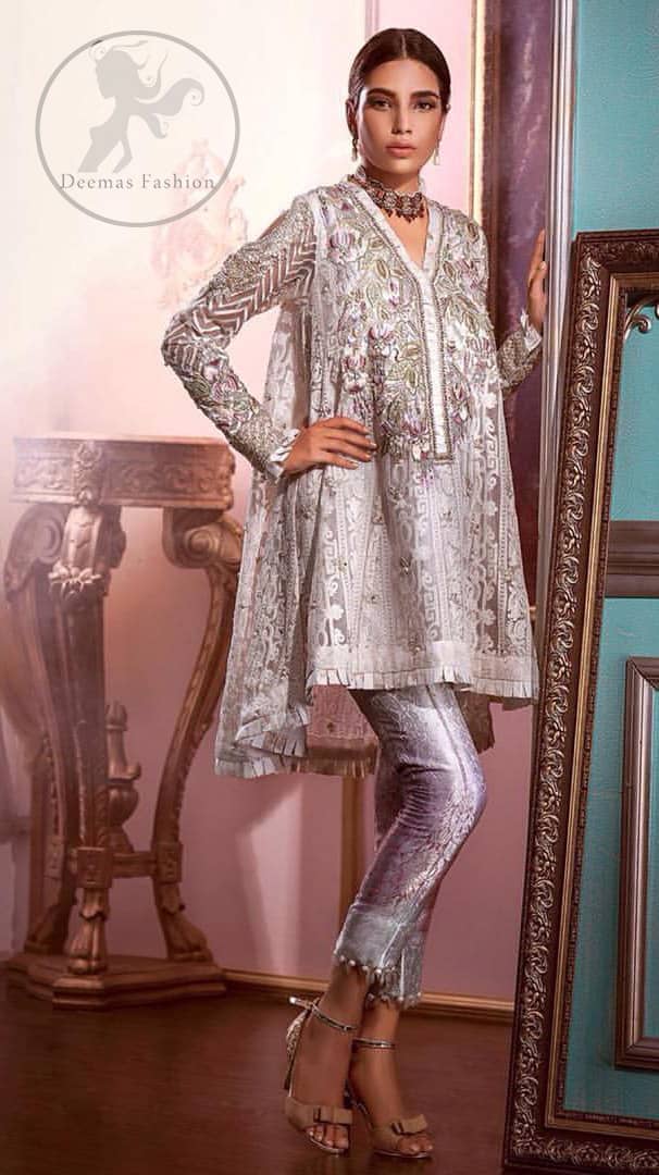 Reflecting exuberant color play in this ethereal piece meticulously highlighted with Swarovski, pearl and silver gold kora dabka. The neckline is fully embellished with multiple color thread embroidery and floral motifs. Cold shoulder sleeves also decorated with silver gold kora dabka , tilla and thread embroidery. It comes with matching chiffon dupatta and pajama.