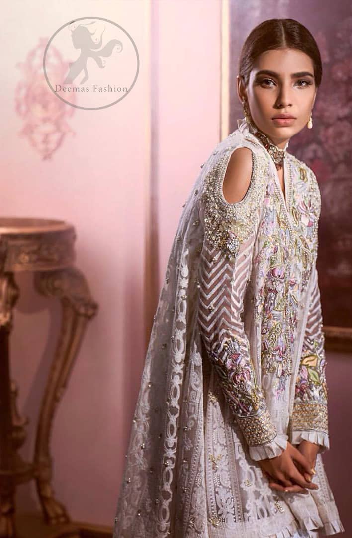 Reflecting exuberant color play in this ethereal piece meticulously highlighted with Swarovski, pearl and silver gold  kora dabka. The neckline is fully embellished with multiple color thread embroidery and floral motifs. Cold shoulder sleeves also decorated with silver gold kora dabka , tilla and thread embroidery. It comes with matching chiffon dupatta and pajama.