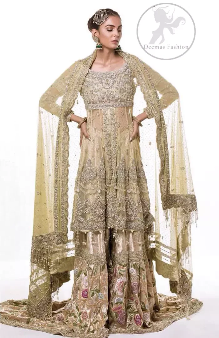 This dress is beautifully sculptured with floral embroidery. It is meticulously highlighted with antique shaded kora, dabka, tilla, sequins and pearls. It is embellished with beautiful tassels which adds to the look. It is artistically paired up with gharara which comprises of floral thread colourful motifs. It comes with chiffon dupatta which has four sided embellished borders and sprinkled with small sized sequins motifs all over it.