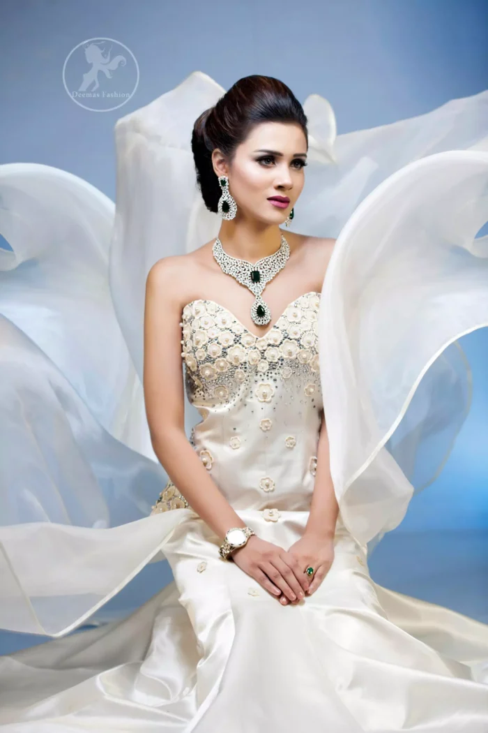 This outfit is a timeless beauty. It is embellished with sweetheart neckline which is decorated with flowers, pearls and swarovski crystal. It is further enhanced with intricate flower patterns on side. It comes with matching brocade pajama and dupatta.