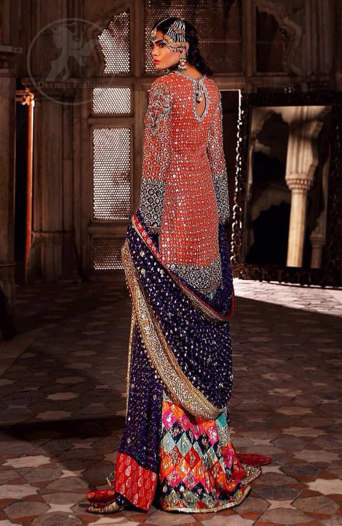 This unique bridal dress is beautifully sculptured with floral thread embroidery. It is meticulously highlighted with silver and antique kora dabka, tilla, sequins and pearls. It is artistically paired up with brocade gharara which is embellished with different color applique. It comes with chiffon dupatta which has four sided embellished border and sprinkled with sequins all over it.