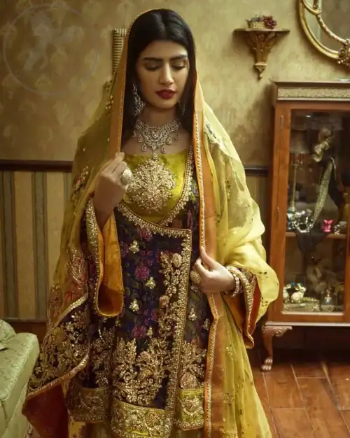 This royal blue angrakha shirt is embellished with resham thread. It is meticulously highlighted with dull golden kora dabka