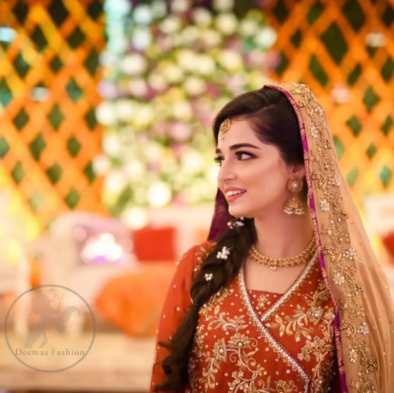 This outstanding outfit is fully embellished with embroidery. It is allured with resham, kora dabka, tilla and pearls. Sleeves are decorated with floral embroidery. Its neckline and hemline is adorned with floral motifs.It comes with embellished sharara which has small sized sprinkled floral motifs at the bottom. This Outfit is beautifully coordinated with dull yellow dupatta with heavy embroidered borders.