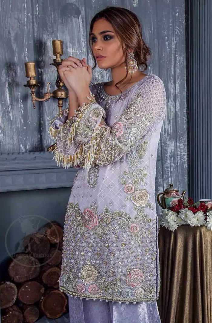 Standout in this gorgeous chiffon shirt embellished with tilla, kora dabka, sequins and pearls.It is further enhanced with floral thread embroidery.Its hemline and sleeves are beautifully decorated with golden tassels.It is beautifully coordinated with self print jacquard trousers. It comes out with chiffon dupatta decorated with sequins spray all over .