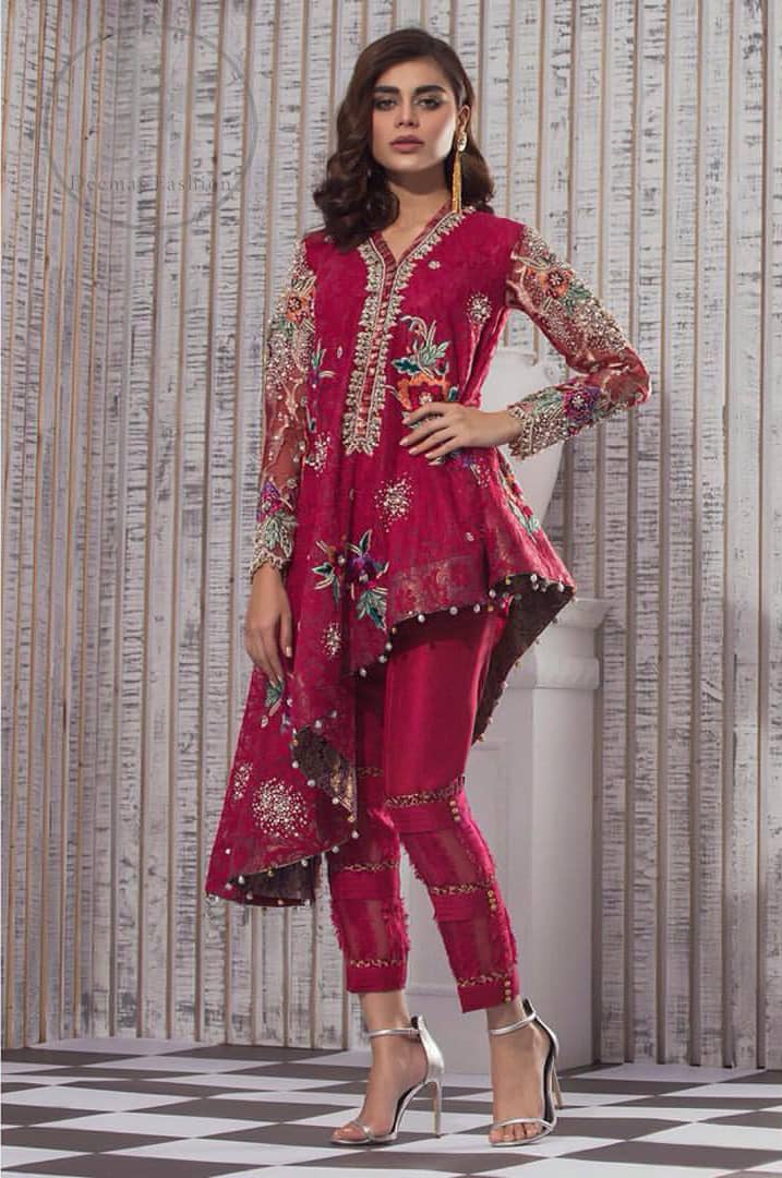 This outfit is embellished with resham thread. It is meticulously highlighted with kora dabka tilla sequins and pearls. Sleeves are adorned with floral embroidery. V-shaped neckline adds to the look. Hemline is allured with beautiful tassels. It comes with shocking pink pants pajama.It is coordinated with chiffon dupatta which is sprinkled with sequins all over.