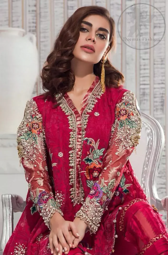 This outfit is embellished with resham thread. It is meticulously highlighted with kora dabka tilla sequins and pearls. Sleeves are adorned with floral embroidery. V-shaped neckline adds to the look. Hemline is allured with beautiful tassels. It comes with shocking pink pants pajama.It is coordinated with chiffon dupatta which is sprinkled with sequins all over.