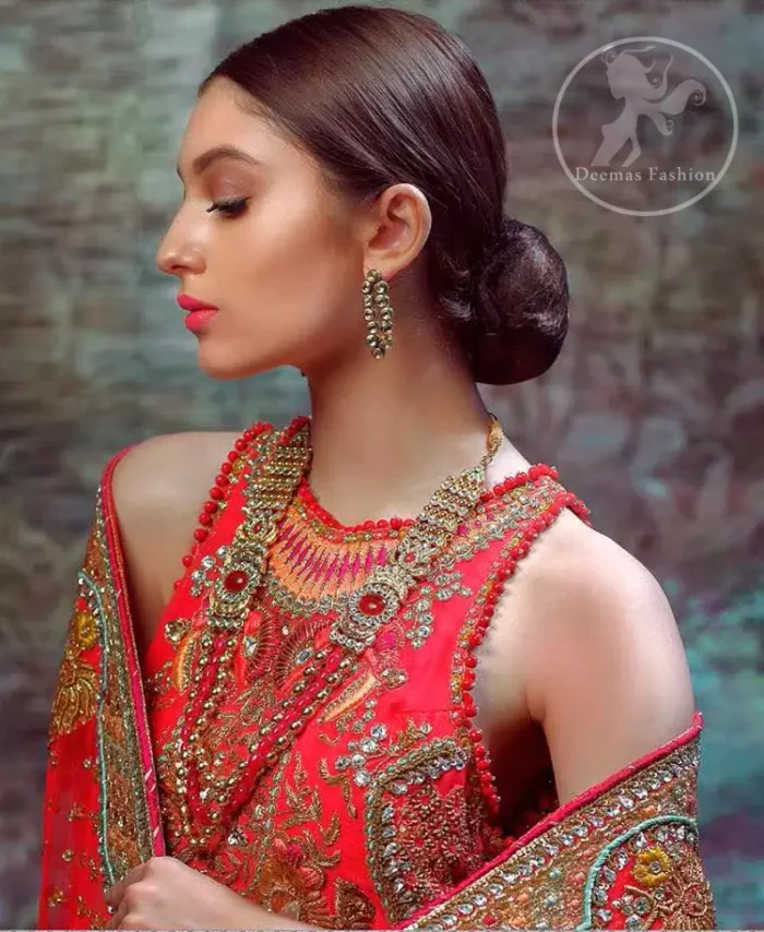 This dress is beautifully sculptured with floral thread embroidery. The halter shaped neckline meticulously highlighted with antique shaded kora, dabka, tilla, sequins and pearls. The shirt is ornamented with multiple color thread embroidered applique. It comes with chiffon dupatta which has four sided embellished border and sprinkled with sequins all over it. It is beautifully paired up with brocade sharara.