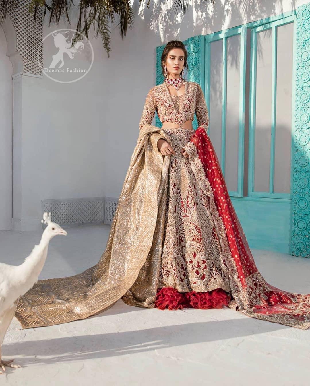 Heavy embellished bridal dress, with V Shaped blouse and skirt encrusted with swarovski stones, pearls, tilla and kora dabka along with a heavy embellished skin shawl. Beautifully paired up with deep red dupatta with sprinkled sequins and heavily embroidered borders. Best combo for a bridal.