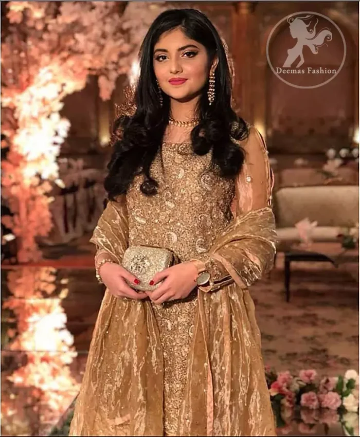 Take a step towards refreshing your wardrobe with this regal dress. The shirt is beautifully adorned with golden kora dabka, kundan, tilla and sequins work along net sleeves. The self-printed brocade sharara is enhanced with lace detail on bottom. It comes with organza dupatta sprinkled sequins on ground.