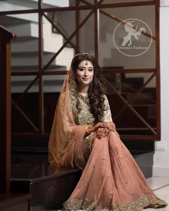 Exude elegance and class in this tissue shirt finessed with beautiful embellishment. The shirt is delicately ornamented with multiple colored zardozi work. Daman of the shirt is enhanced with lace. It comprises with antique brass sharara adorned with thick embellished borders and sprinkled sequins. It coordinated with antique brass dupatta with embellished borders on length of dupatta.