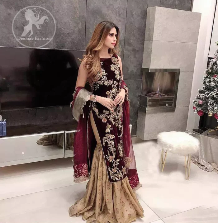 Take a step towards refreshing your wardrobe with maroon velvet dress. This maroon shirt is heavily embellished in the front with silver gold kora dabka, kundan, tilla and sequins. Finished with golden brocade self-printed gharara. This outfit is beautifully coordinates with maroon dupatta with embroidered borders on all four sides .