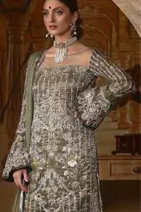 The beautiful bodice is decorated with intricate stones and sequins. It is further enhanced with vertical lines and floral motifs done with kora dabka, tilla, sequins and colorful thread work. Paired up with embroidered bell bottom. This outfit is beautifully coordinated with olive green dupatta with embellished borders on sides and sprinkled sequins.