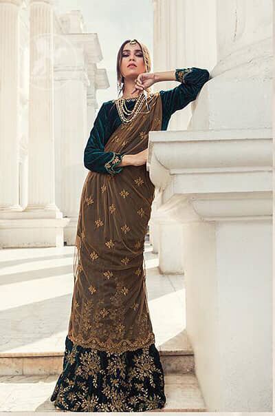 Take a step towards refreshing your wardrobe with bottle green velvet Shirt. The shirt is perfected with delicate gold tilla work. Add this bottle green velvet golden embellished bell bottom for a complete look. It comes with golden net dupatta enhanced with small motifs on the ground.