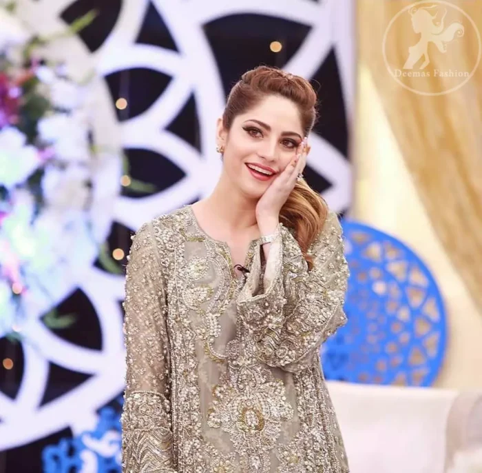 This dress is beautifully sculptured with floral embroidery. It is allured with kora, dabka, tilla, sequins and pearls. Bell shaped sleeves adds to the look. It comes with pants which is allured with buttons. It is coordinated with chiffon dupatta, sprinkled with sequins all over it.