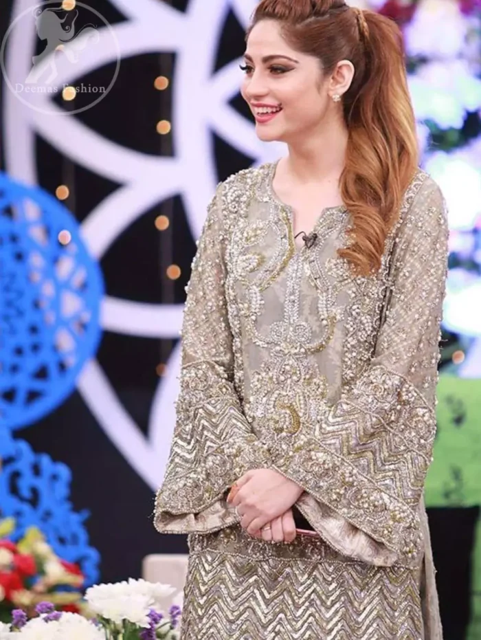 This dress is beautifully sculptured with floral embroidery. It is allured with kora, dabka, tilla, sequins and pearls. Bell shaped sleeves adds to the look. It comes with pants which is allured with buttons. It is coordinated with chiffon dupatta, sprinkled with sequins all over it.