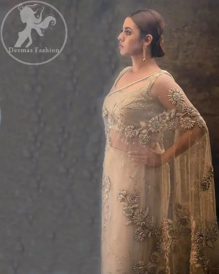 This dress is beautifully sculptured with floral embroidery. Pallu is highlighted with kora, dabka, tilla, sequins and pearls. It comes with fully embroidered sleeveless blouse which adds to the look.