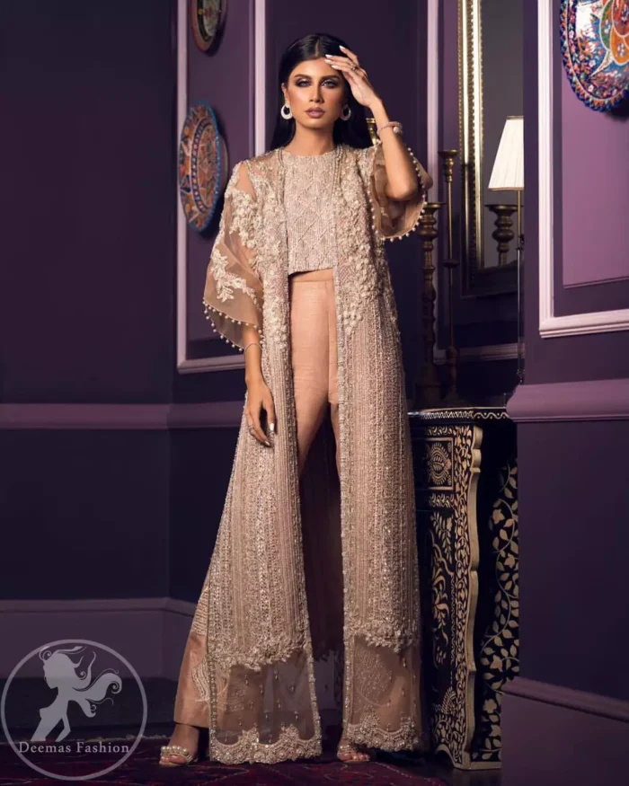 This dress is decorated with floral embroidery. It is highlighted with kora, dabka, tilla, sequins and pearls. Gown is adorned with scalloped border and tassels which adds to the look. It comes with trousers. It is coordinated with organza dupatta which is sprinkled with sequins all over it.