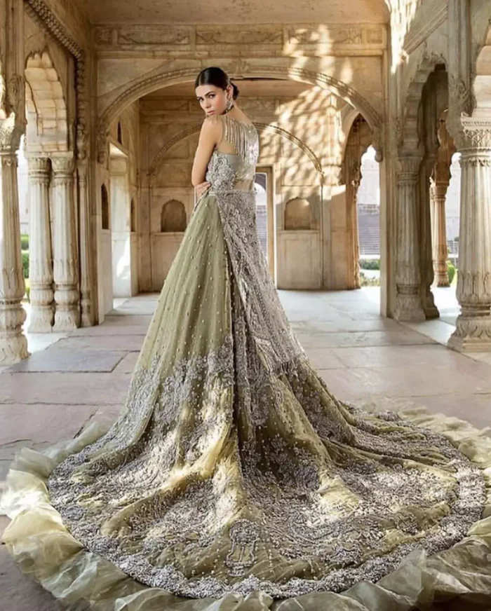 Redefine your style in this traditional and versatile ensemble ornamented with floral pattern embroidery furnished with silver shaded kora, dabka, tilla, sequins, kundan and pearls. It comes with heavily embellished lehengha, adorned with frill which adds to the look. It is stunningly coordinated with taupe gray dupatta with embellished borders on all sides and sequins spray all over it.